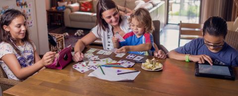 vrouw met kinderen aan tafel